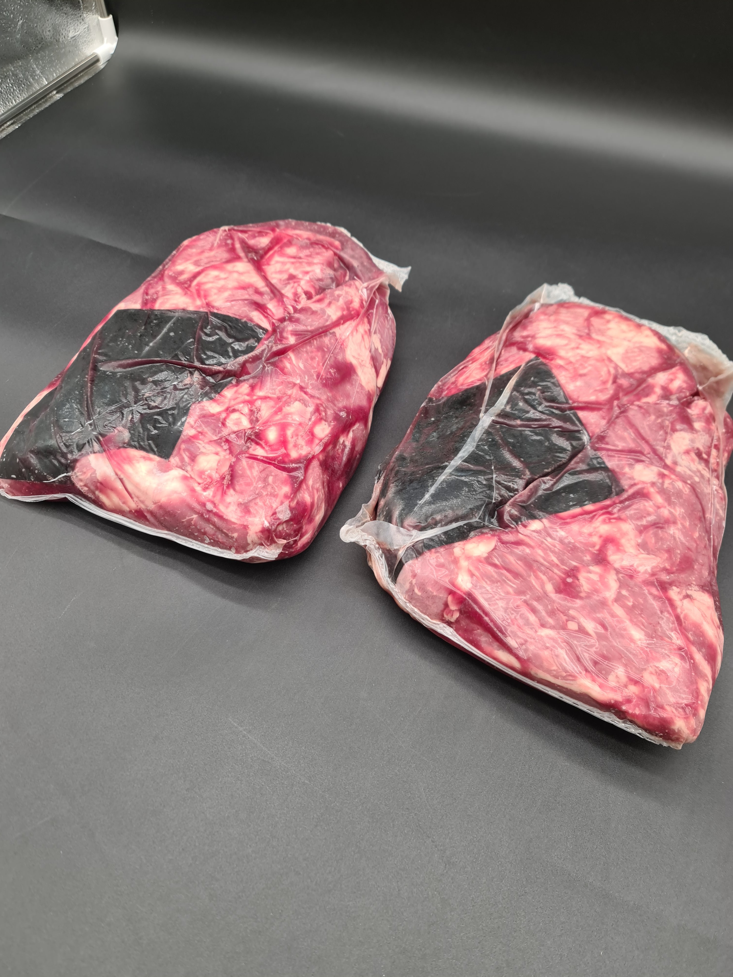 Angled view of packed premium meat cuts in a box