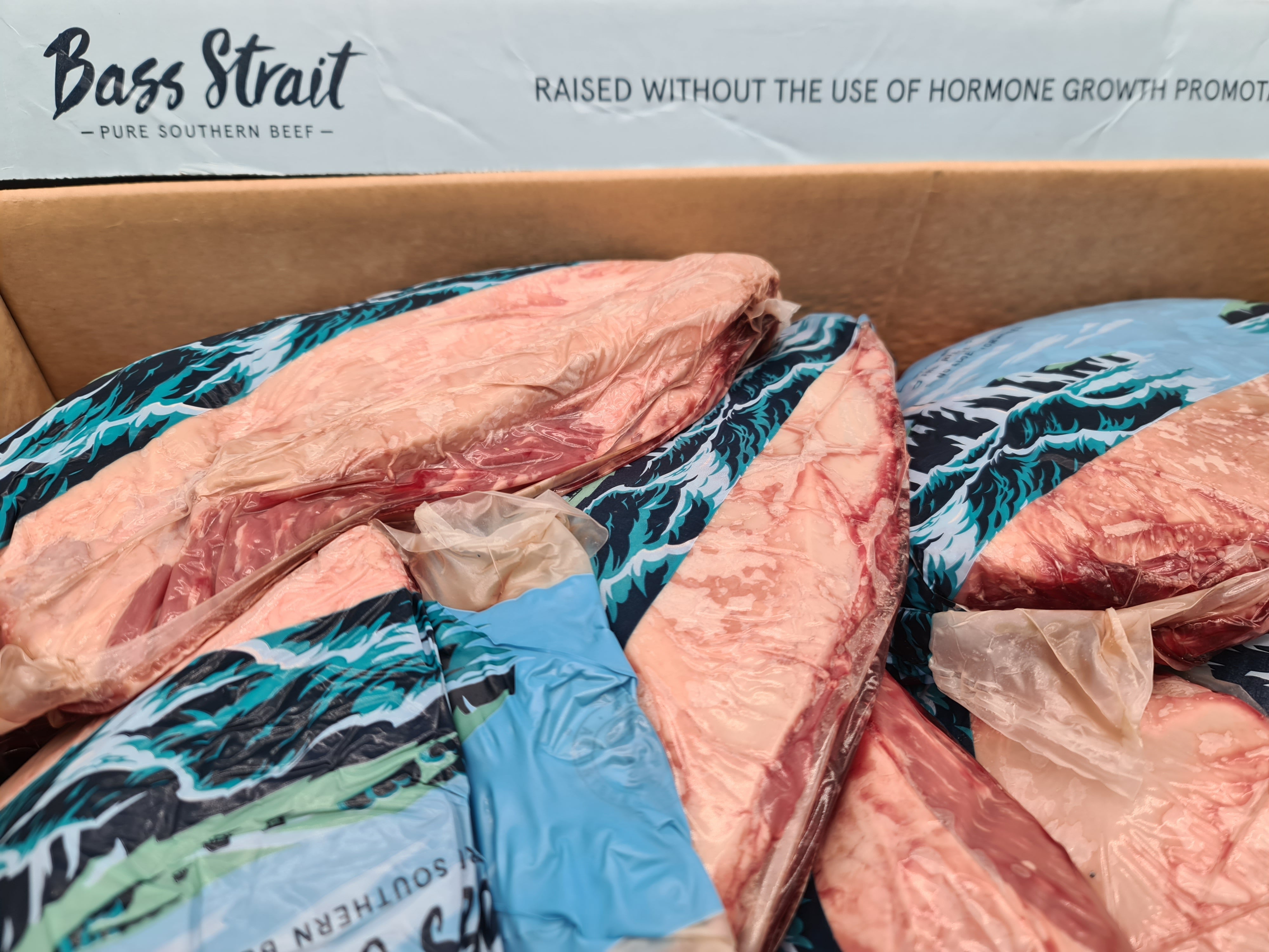 Top view of premium meat cuts packed inside an open box