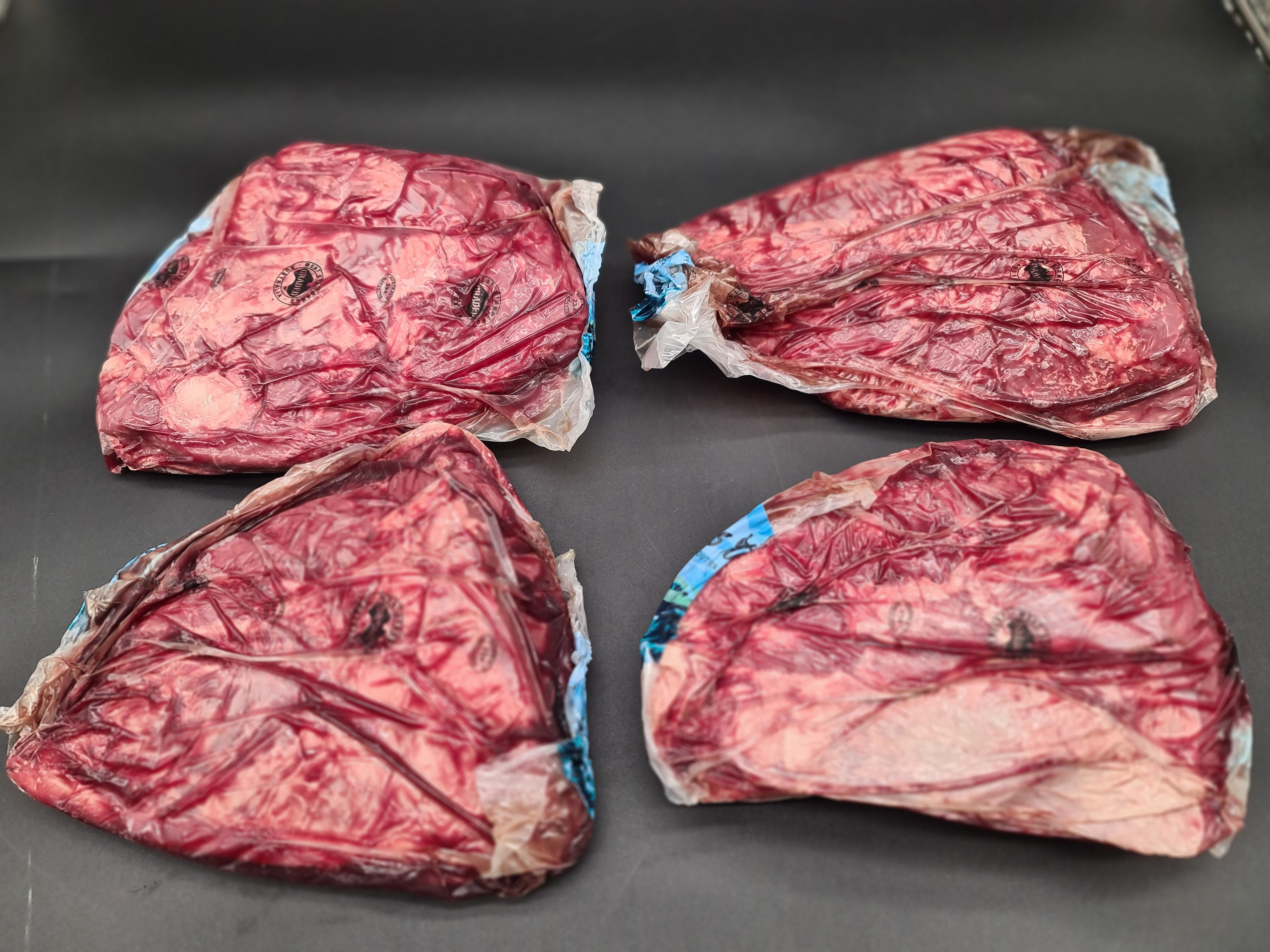 Two premium meat cuts side by side in vacuum packaging